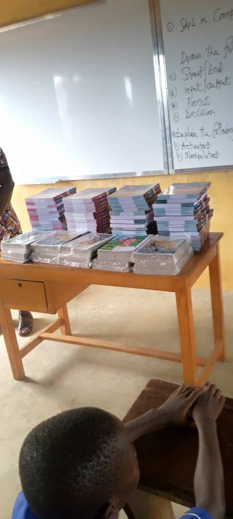 Stacks of new books arranged on a classroom desk ahead of distribution to pupils